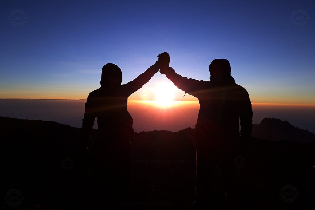 reaching kilimanjaro top celebration