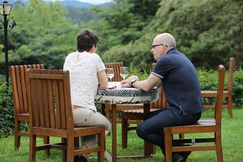 Guests relaxed at camp at sunset, drinks in hand, trip already secured