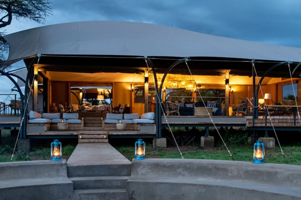  Luxury or mid-range tented camp in the northern Serengeti at sunset
